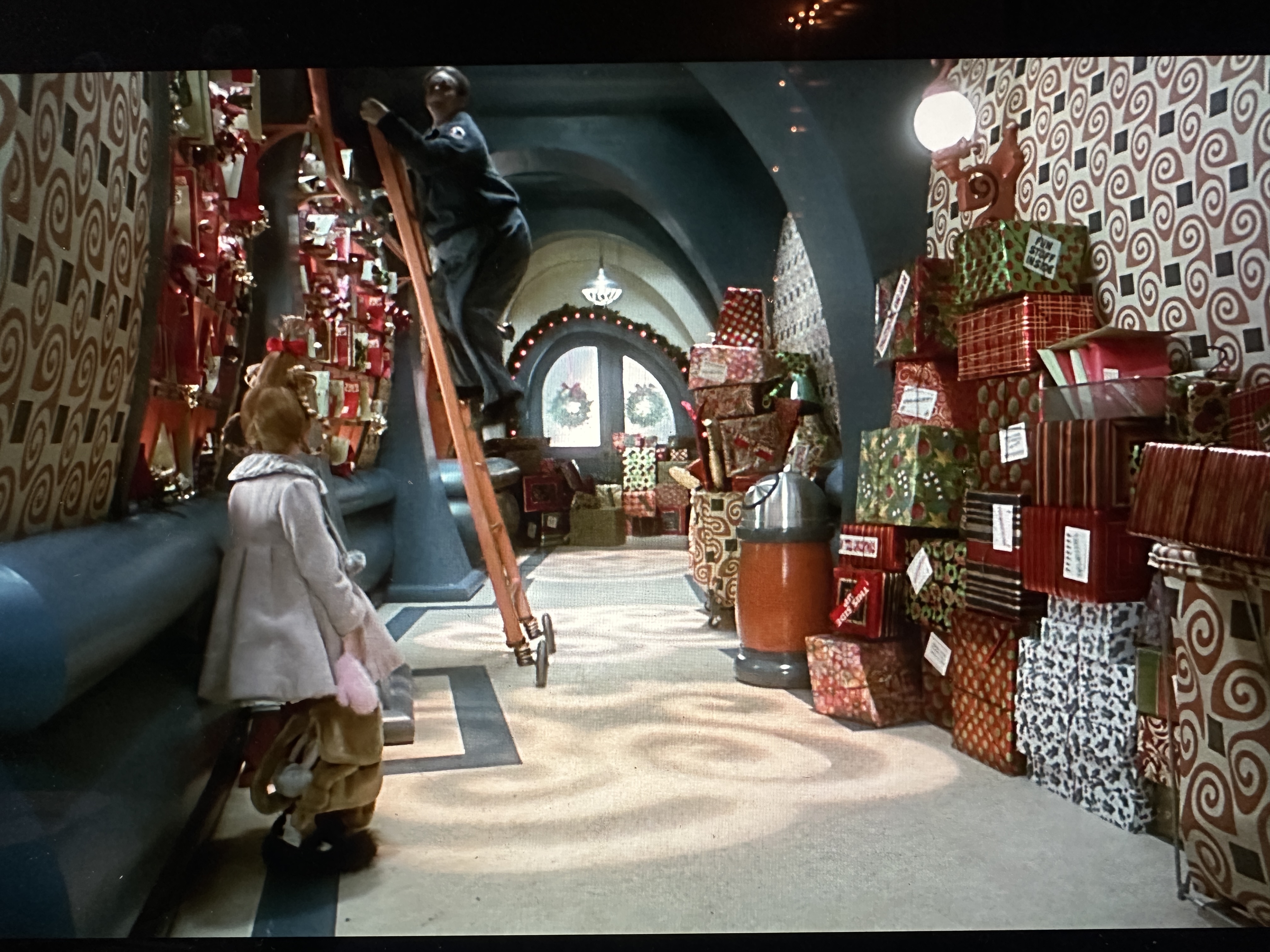 Image of Cindy Lou Who and her father in the post office looking at all of the mail.