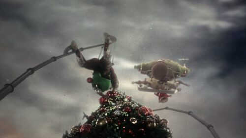 Image of a who putting the star on the Christmas tree in town square.